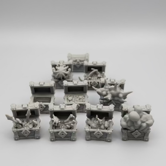 Set of small gray toy chests on a white background