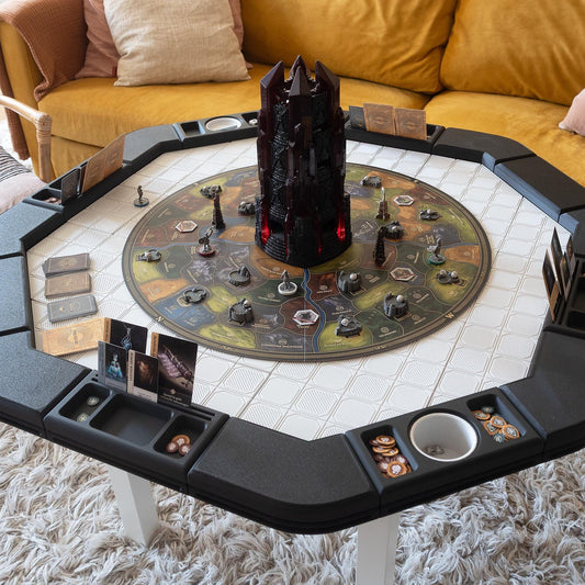 A 3D printed black gaming table topper with storage compartments, mounted on a white surface, with a game set up on it.