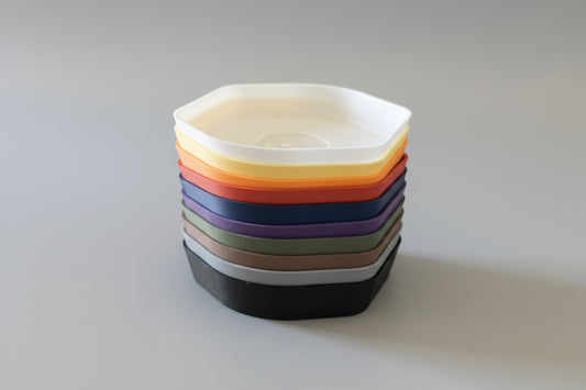 Stack of colorful  containers on a white surface